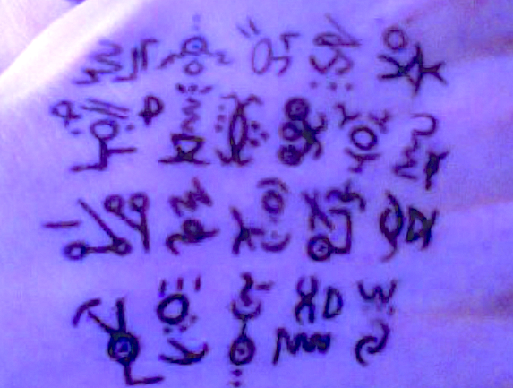 An image of alien symbols drawn on the back of a hand